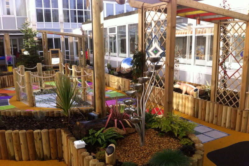 A sensory garden with water features and shaped log planters