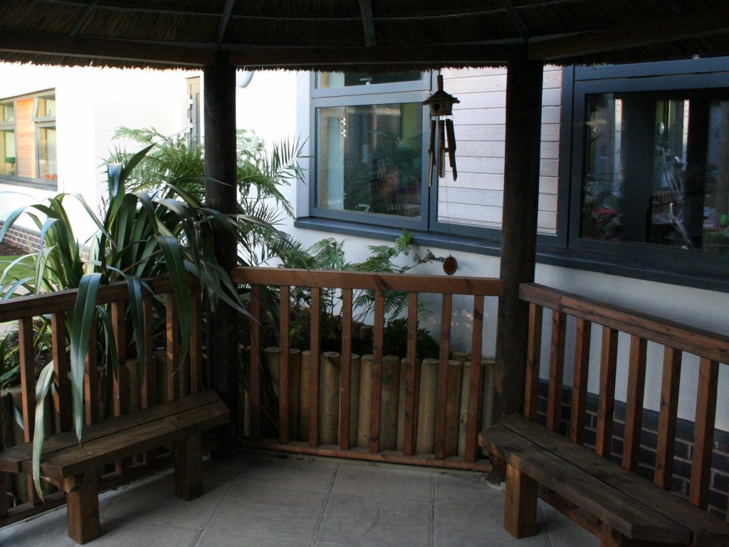 Inside Thatched Gazebo Offering Shade, Seating and Wheel Chair Access in Dementia Sensory Garden