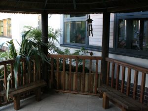 Inside Thatched Gazebo Offering Shade, Seating and Wheel Chair Access in Dementia Sensory Garden Inside Thatched Gazebo Offering Shade, Seating and Wheel Chair Access in Dementia Sensory Garden