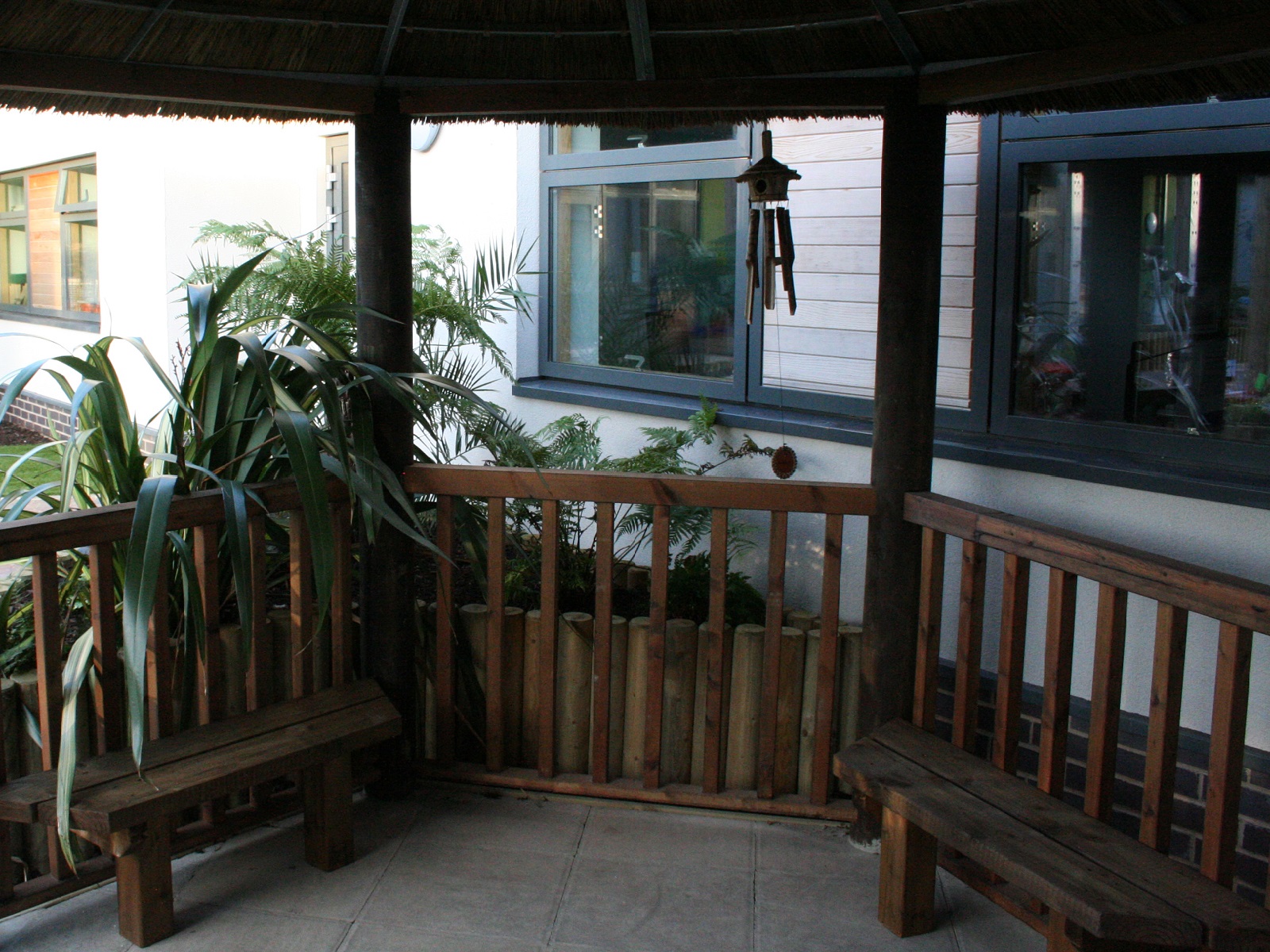 Inside Thatched Gazebo Offering Shade, Seating and Wheel Chair Access in Dementia Sensory Garden Inside Thatched Gazebo Offering Shade, Seating and Wheel Chair Access in Dementia Sensory Garden