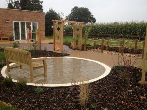 Textured Pathways and Interactive Jumping Jets for a Sensory Garden Client