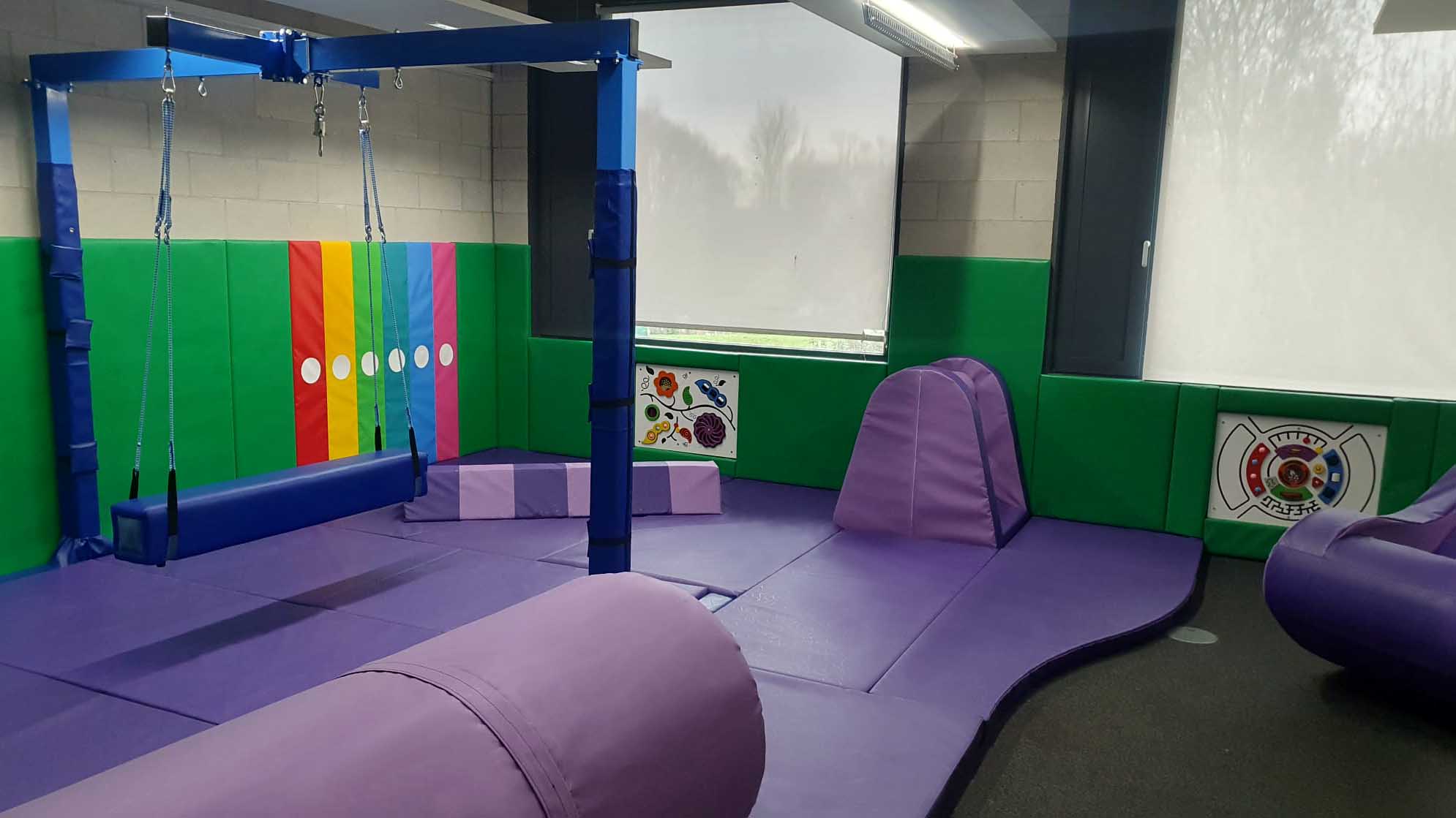 Safe and engaging sensory integration space with padded flooring, mood lighting and activity zones