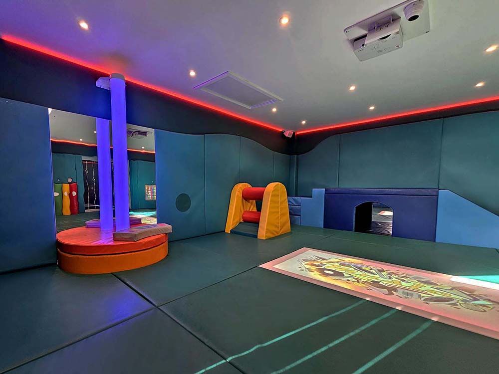 Sensory soft play room featuring padded play equipment and interactive elements