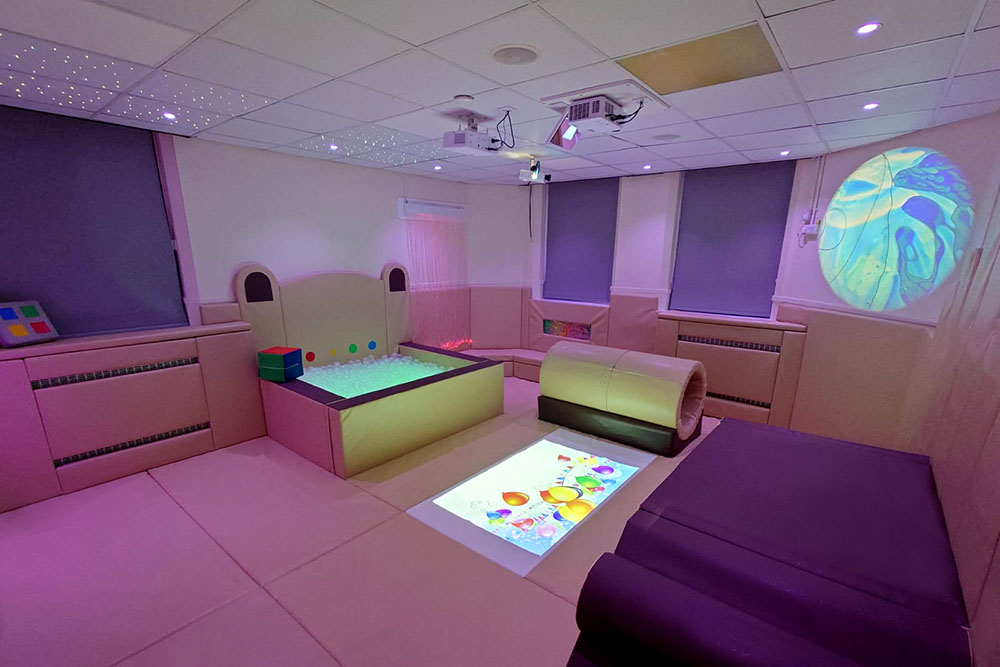 Hybrid sensory soft play room combining active play equipment with sensory features